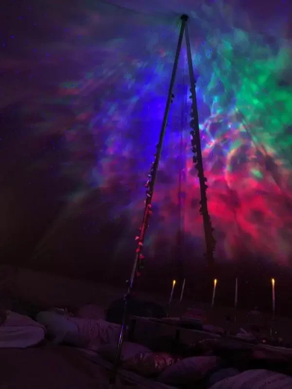 A Texas party rental tent with colorful lights in the middle of it.