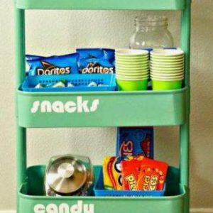 A green party rental cart with snacks and drinks on it, located in Texas.