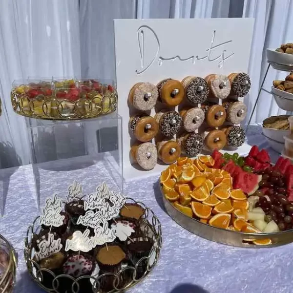 A party rental table with donuts and fruit on it, in Texas.