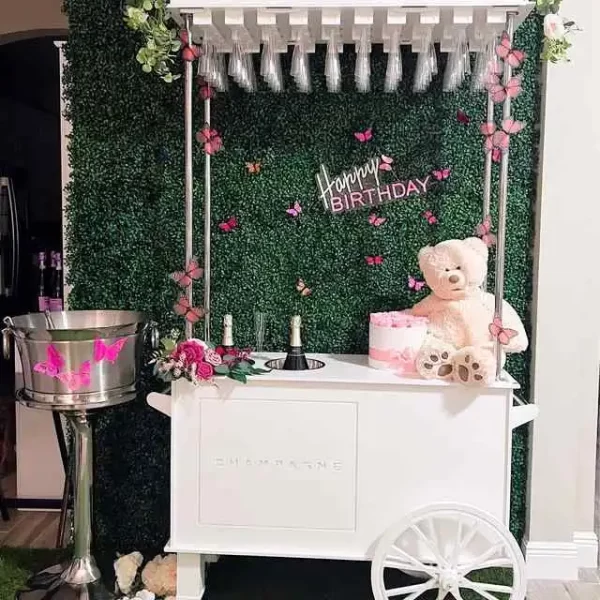 An ice cream cart with teddy bears and flowers, available for party rental in Texas.