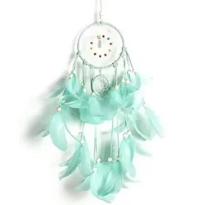 A turquoise dream catcher hanging on a white wall at a Texas party rental.