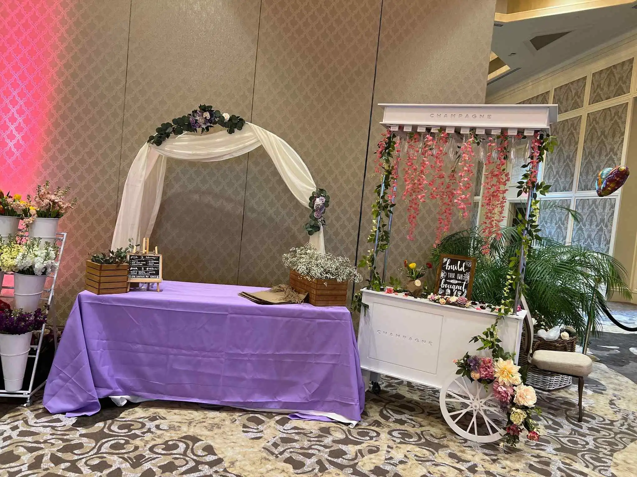 A table adorned with enchanting flowers and a purple tablecloth.